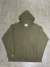 A BATHING APE (BAPE) × KAWS / “CHUM" NOSE ART GRAPHIC FULL-ZIP HOODIE (OLIVE DRAB)